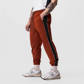 Nový športový dizajn fitness mužov príležitostné športové nohavice, reflexné pásky elastické vonkajšie beh cvičenie rýchle sušenie pánske nohavice